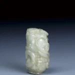 西漢 和闐玉雕水銀沁夒龍乳丁紋圓勒子